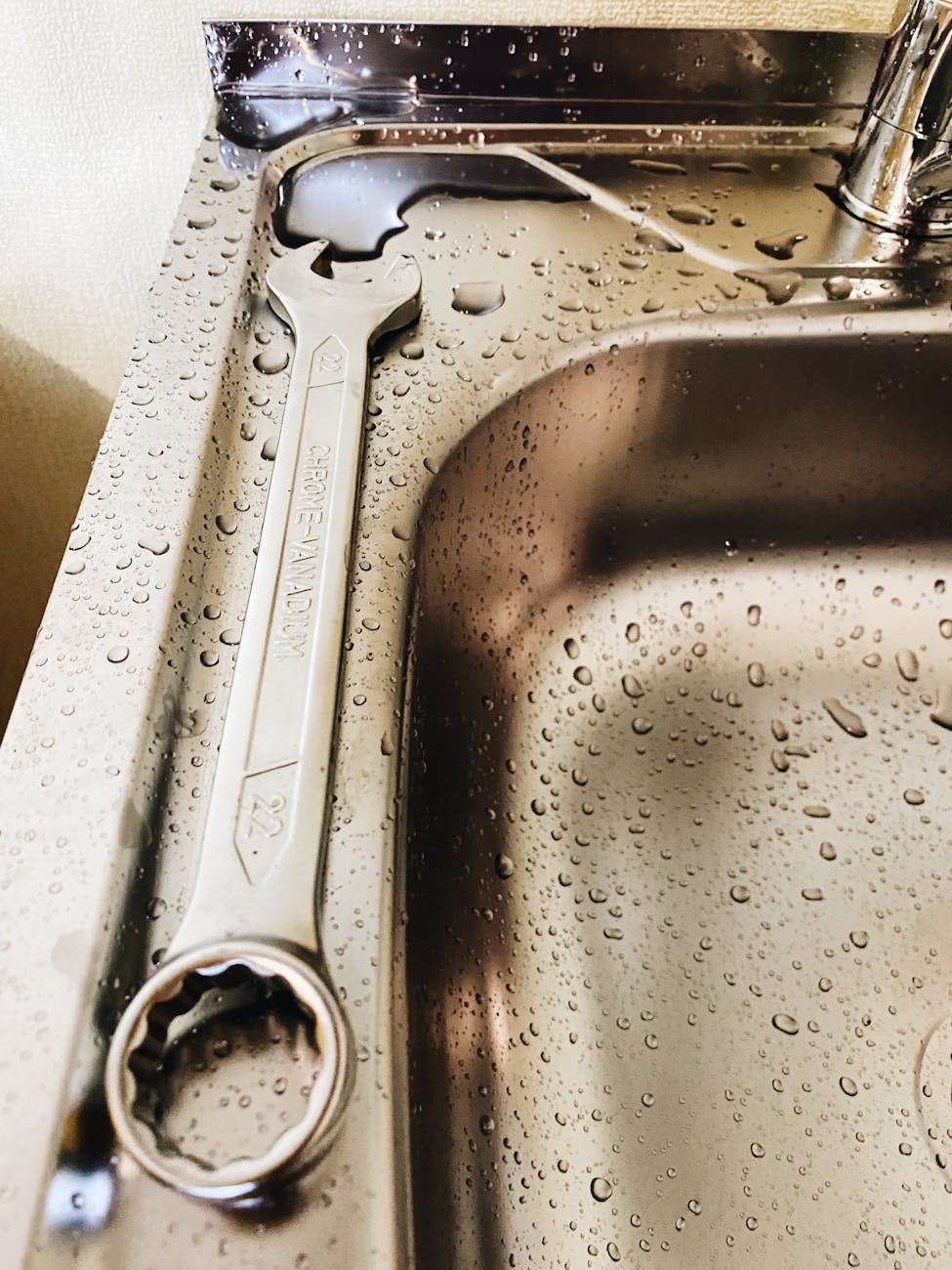 a spanner on stainless steel sink